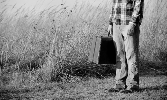 A guy with a suitcase.